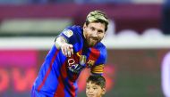 Barcelona's Lionel Messi talks to his Afghan superfan Murtaza Ahmadi on the pitch before the start of their friendly match against Saudi Arabia's  Al Ahli FC in this December 13  file photo.