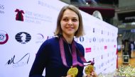 Ukraine's grandmaster Anna Muzychuk celebrates after winning both FIDE  World Chess Rapid and Blitz Championships, in Doha  yesterday.