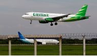 A Citilink Airbus A320 approaches for a landing at Soekarno-Hatta International Airport in Jakarta June 14, 2013. REUTERS/Enny Nuraheni/File Photo