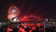 A family fireworks illuminates the sky above the iconic Opera House in Sydney on December 31, 2016, ahead of New Years fireworks. AFP / SAEED KHAN