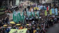 Protesters including pro-democracy lawmakers Lau Siu-lai (bottom C), Edward Yiu (behind Lau) and Nathan Law (bottom L) carry a banner reading 
