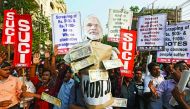 Activists of the Socialist Unity Centre of India (SUCI) shouting slogans as they carry an effigy of Prime Minister Narendra Modi during a protest against government's decision of demonetisation.