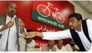 FILE PHOTO:  Akhilesh Yadav of Uttar Pradesh adjusts microphone for his father the Samajwadi Party President Mulayam Singh Yadav during a meeting in Lucknow March 10 2012 (Reuters) 