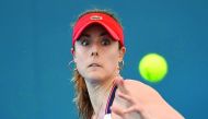 Alize Cornet of France hits a return against Elena Vesnina of Russia during the first round of the Brisbane International tennis tournament in Brisbane, Australia yesterday.