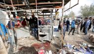 People look at wreckage at the site of car bomb attack in a busy square at Baghdad's sprawling Sadr City district, in Iraq January 2, 2017. REUTERS/Ahmed Saad.