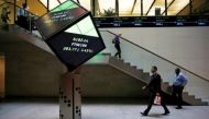 People walk through the lobby of the London Stock Exchange in London, Britain August 25, 2015. REUTERS/Suzanne Plunkett/File photo.