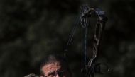 Hunter, Javier Sintes training with his bow on the outskirts of San Agustin de Guadalix near Madrid on December 12, 2016. It's a scene straight out of Medieval times set in modern-day Madrid: an archer dressed in camouflage gear, stationed in a tree at ni