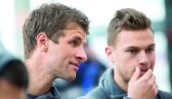 Bayern Munich's forward Thomas Mueller (left) and Bayern Munich's midfielder Joshua Kimmich arrive at the airport in southern Germany before the departure of the team to Qatar.