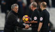 Manchester United's Portuguese manager Jose Mourinho (L) shakes hands with referee Mike Dean on the pitch after the English Premier League football match between West Ham United and Manchester United at The London Stadium, in east London on January 2, 201