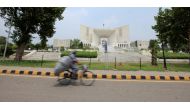 A man rides a bicycle past the Supreme Court building in Islamabad, Pakistan (REUTERS)
