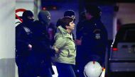 Member of the militant Revolutionary Struggle group Paula Roupa (centre) is escorted by anti-terrorist police officers during her transfer in a court in Athens, yesterday.