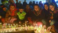Sikh devotees light candles on occasion of the 350th birth anniversary of the 10th Sikh Guru Gobind Singh at the Sikh Shrine Golden Temple in Amritsar, yesterday.