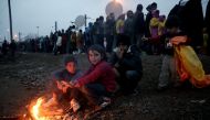 Refugees queue in a line to receive food from volunteers at the refugee camp in Idomeni, Greece, as they wait to be allowed to cross the border with FYROM, 29 February, 2016 (EPA / SIMELA PANTZARTZI)