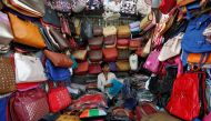 A vendor arranges bags as he waits for customers at his shop at a market in Mumbai, India, January 6, 2017. REUTERS/Danish Siddiqui