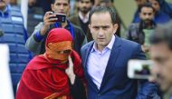 The wife of a Pakistani judge, accused of torturing her 10-year-old maid,  is escorted by her brother as they leave the Supreme Court in Islamabad, yesterday. 
