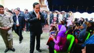 Thai Prime Minister Prayuth Chan-ocha gestures in traditional greeting during a visit at Ra-ngae district, yesterday.