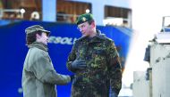 German Force commander General Major Josef Dieter Blotz (right) talks to a US military service personnel at the harbour in Bremerhaven, yesterday.