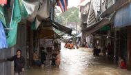Residents stand in floodwaters in the southern Thai village of Chauat on January 7, 2017. Heavy rains continued to hammer Thailand's flood-ravaged south on January 7, bringing the death toll up to 12 and leaving thousands of villages partially submerged, 