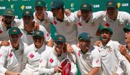 Australia's captain Steve Smith holds the trophy as he poses with team mates on the Sydney Cricket Ground. (REUTERS/David Gray)