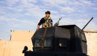 A member of the Iraqi special forces Counter Terrorism Service (CTS) patrols a street with an armoured vehicle in Mosul's Al-Zahraa neighbourhood on January 7, 2017 during an ongoing military operation against the Islamic State (IS) group.  AFP / Dimitar 