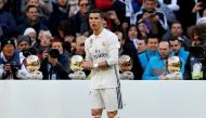 Real Madrid's Cristiano Ronaldo poses with his 4th Ballon d'Or (Golden Ball) before their Spanish first division soccer match against Granada. REUTERS/Juan Medina
