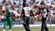 Corey Anderson (L) and Colin de Grandhomme of New Zealand shake hands during the 20/20 International cricket match between New Zealand and Bangladesh at Bay Oval in Mount Maunganui on January 8, 2017. (AFP / MICHAEL BRADLEY)