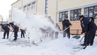 Romanian gendarmes shovel snow in the courtyard of a school in Bucharest, Romania January 10, 2017. Inquam Photos/Octav Ganea/via REUTERS