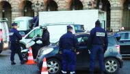 French policemen control drivers on January 10, 2016 as part of a Crit'air eco-vignette control operation on the place de la Concorde in Paris. In total, 533,540 anti-pollution vignettes 