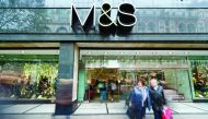  This file photo taken on November 06, 2012 shows people walking past a Marks & Spencer store in central London on November 6, 2012. British food-to-clothing retailer Marks and Spencer announced a share price jump of 2.7 percent after the group revealed a