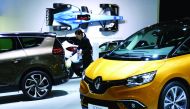 A worker cleans a Renault car at the European Motor Show in Brussels, Belgium, yesterday.