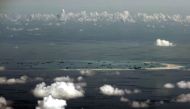  An aerial photo taken though a glass window of a Philippine military plane shows the alleged on-going land reclamation by China on mischief reef in the Spratly Islands in the South China Sea, west of Palawan, Philippines, May 11, 2015. REUTERS/Ritchie B.