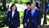 Taiwan's President Tsai Ing-wen (left) walks with El Salvador's President Salvador Sanchez Ceren before a decoration ceremony at the presidential house in San Salvador, El Salvador, yesterday.