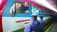 A train conductor speaks with local station workers at the main railway station in Belgrade on January 14, 2017. A train from Russia, decorated with the Serbian flag and artwork featuring Serbian churches, monasteries and medieval towns, plans to begin tr