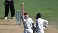 New Zealand's captain Kane Williamson (L) celebrates 100 runs with teammate Henry Nicholls during day five of the first international Test cricket match between New Zealand and Bangladesh at the Basin Reserve in Wellington on January 16, 2017. (AFP / Mart