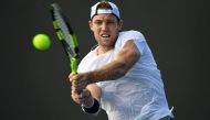 Jack Sock of the US hits a return against France's Pierre-Hughes Herbert during their men's singles match on day one of the Australian Open tennis tournament in Melbourne on January 16, 2017. AFP / Saeed KHAN