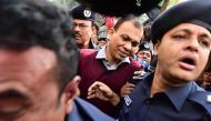 Bangladeshi Commander in the Rapid Action Battalion (RAB) Tarek Sayeed is escorted by police at Narayangong court in Narayangong on January 16, 2017. A Bangladesh court January 16 sentenced 26 people to death after hearing how a politician from the ruling