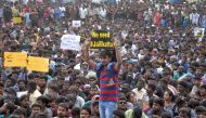 People attend a protest demanding to reverse a Supreme Court ban on the traditional bull-taming contests, known as Jallikattu, at the Marina beach in Chennai, India, January 19, 2017. (REUTERS)