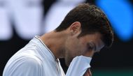 Serbia's Novak Djokovic reacts after a point against Uzbekistan's Denis Istomin during their men's singles match on day four of the Australian Open tennis tournament in Melbourne on January 19, 2017.  AFP / PAUL CROCK