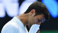 Serbia's Novak Djokovic reacts during the men's singles match of the Australian Open tennis tournament in Melbourne on Thursday. Djokovic lost 7-6 (8), 5-7, 2-6, 7-6 (5), 6-4 to No. 117-ranked Istomin.  