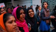 Indian women shout slogans as they participate in a nationwide 