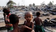 Boys stand among debris after fire destroyed shelters at a camp for internally displaced Rohingya Muslims in the western Rakhine State near Sittwe, Myanmar Reuters.