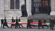 Soldiers of a honor guard carry the Hungarian flag in front of the parliament in Budapest on January 23, 2017 during a natinal day of mourning in Hungary to commemorate victims of a bus accident in Italy. Hungary was holding a national day of mourning to 