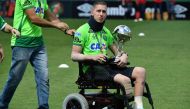 Brazilian Chapecoense goalkeeper Jackson Follmann, a survivor of the LaMia airplane crash in Colombia, holds the Copa Sudamericana trophy at the Arena Conda stadium in Chapeco, Santa Catarina state, in southern Brazil on January 21, 2017, before a friendl