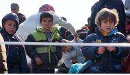 Children arrive along with other aboard a Greek coast guard boat to the port of Mytilene on the Greek island of Lesbos on March 29, 2016, after being rescued by Frontext and Greek coast guards. ©AFP.