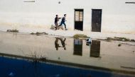 Iraqi students run in a school yard at a school in Mosul's eastern Gogjali neighbourhood on January 23, 2017, as scores of schools resumed their activities in the areas government forces recently recaptured from the Islamic State (IS) group during the gov