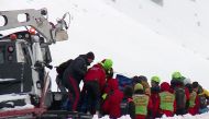 This video grab shows rescuers working to evacuate the bodies of six people killed in an helicopter crash, on January 24, 2017 in the mountains near the ski resort of Campo Felice, central Italy. The chopper came down near the ski resort of Campo Felice i