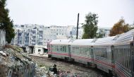 A train travels through Aleppo's devastated eastern districts for the first time in more than four years, yesterday. It is the train's first such trip since rebels overran east Aleppo in the summer of 2012, effectively dividing the northern city into a re