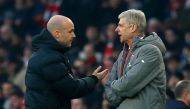 (FILES) In this file photo taken on January 22, 2017 Fourth official Anthony Taylor (L) points Arsenal's French manager Arsene Wenger (R) to the tunnel after he was sent off by English referee Jonathan Moss (not pictured) during the English Premier League