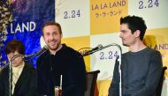 Canadian actor Ryan Gosling (centre) answers questions as US director Damien Chazelle looks on during a press conference for their film 'La La Land' in Tokyo, yesterday.