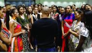 Miss Universe candidates listen to a briefing from an instructor during a rehearsal for the upcoming beauty pageant on Monday, in Manila.